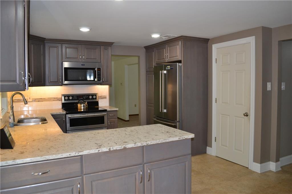 5913 Graybrook Drive Export, PA 15632 - Photo 11 of 24 a kitchen with sink a stove and refrigerator