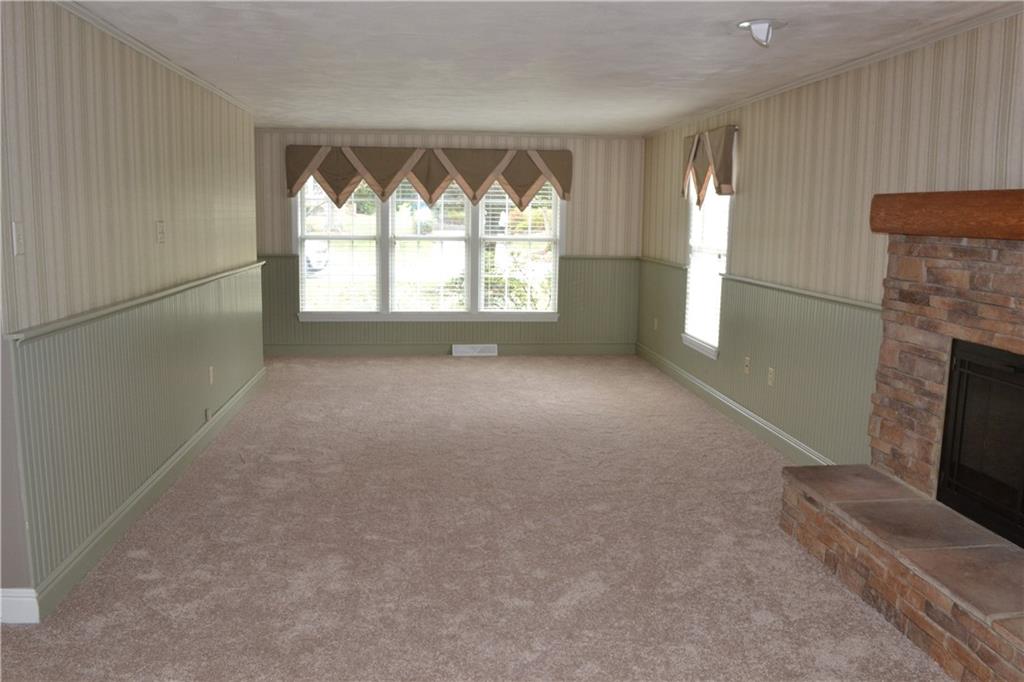 5913 Graybrook Drive Export, PA 15632 - Photo 4 of 24 an empty room with windows and fireplace
