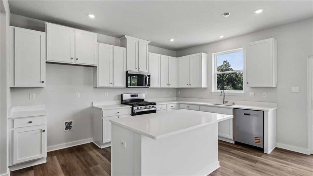 1099 Peachtree Road Carnegie, PA 15106 - Photo 3 of 25 a kitchen with cabinets appliances wooden floor and a sink