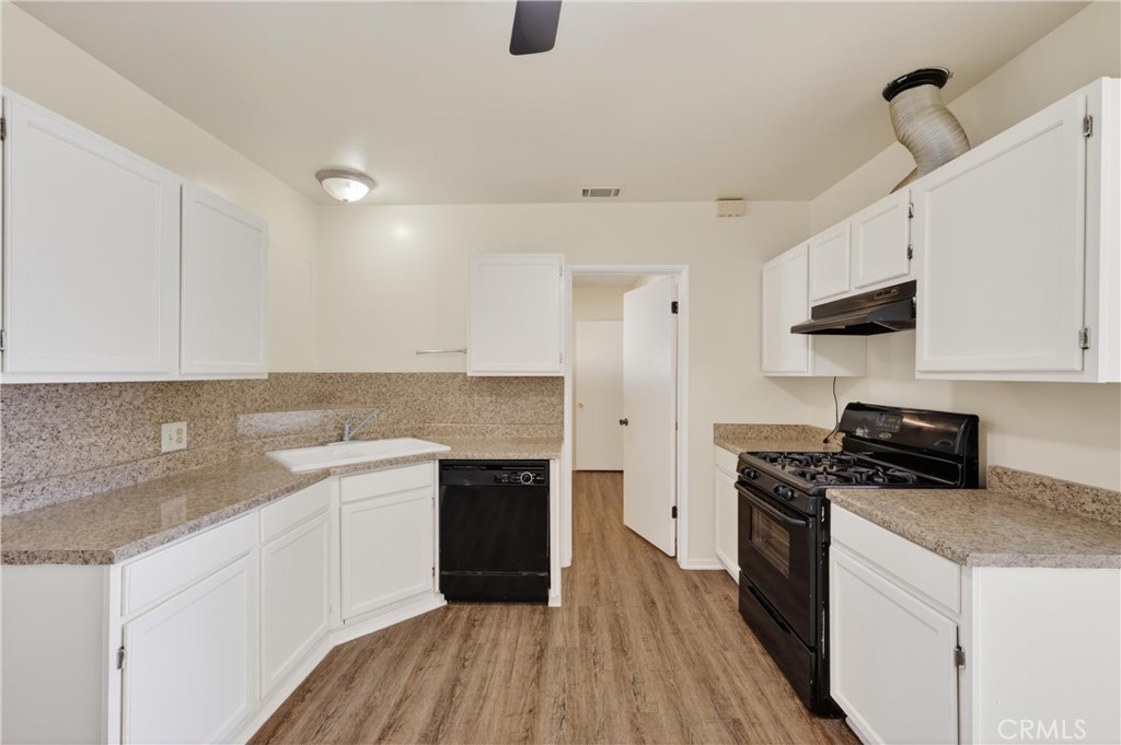 8971 Glencoe Drive Riverside, CA 92503 - Photo 14 of 41 a kitchen with a sink stove top oven and cabinets