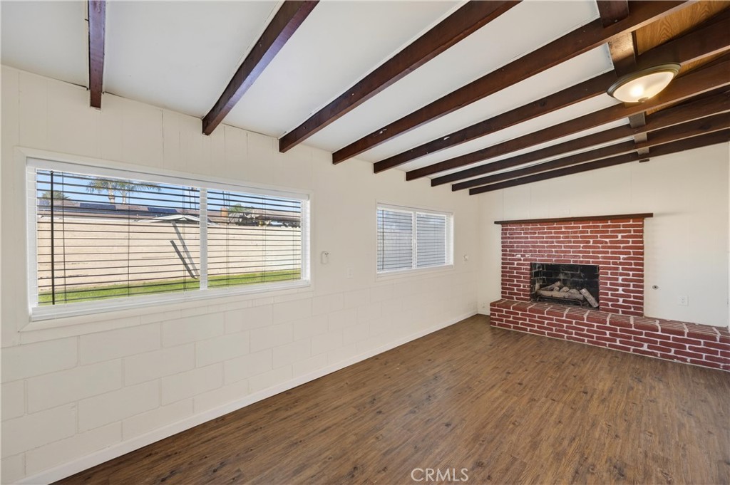 8971 Glencoe Drive Riverside, CA 92503 - Photo 19 of 41 a view of an empty room with wooden floor fireplace and a window