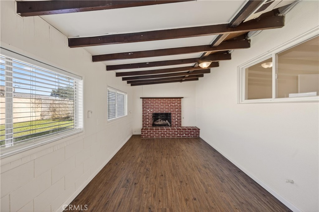 8971 Glencoe Drive Riverside, CA 92503 - Photo 20 of 41 a view of an empty room with wooden floor fireplace and a window