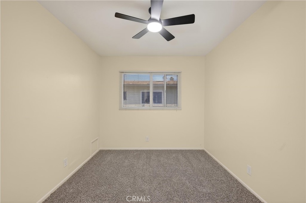 8971 Glencoe Drive Riverside, CA 92503 - Photo 25 of 41 an empty room with a window and a ceiling fan