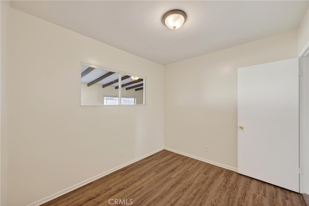 8971 Glencoe Drive Riverside, CA 92503 - Photo 29 of 41 an empty room with wooden floor and windows
