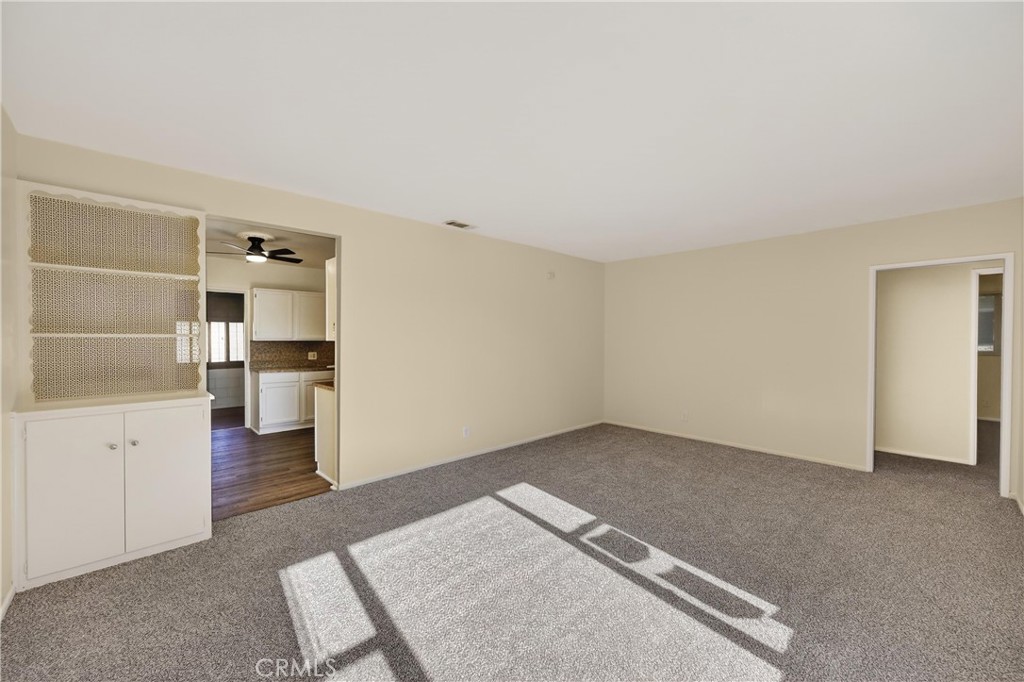 8971 Glencoe Drive Riverside, CA 92503 - Photo 7 of 41 an empty room with cabinet and wooden floor