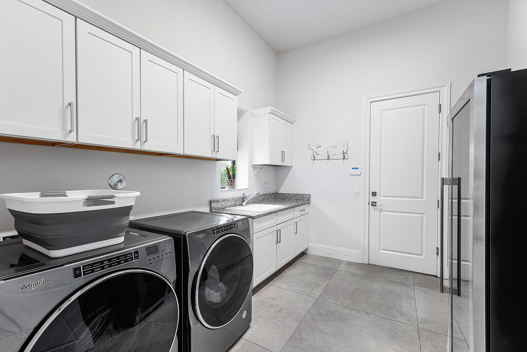 2707 Northwest 75th Street Boca Raton, FL 33496 - Photo 20 of 74 a utility room with sink dryer and washer