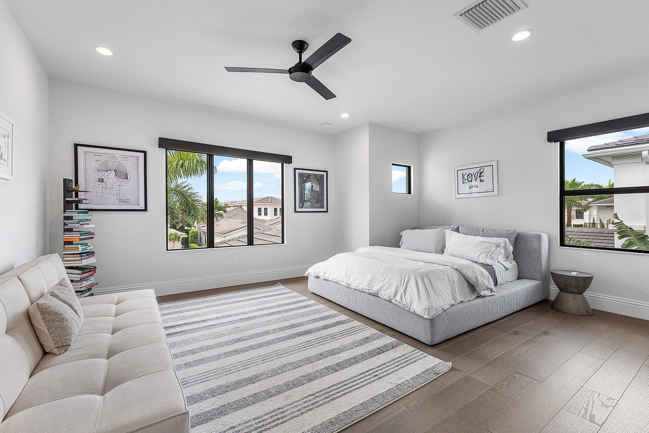 2707 Northwest 75th Street Boca Raton, FL 33496 - Photo 30 of 74 a spacious bedroom with a large bed and a large window