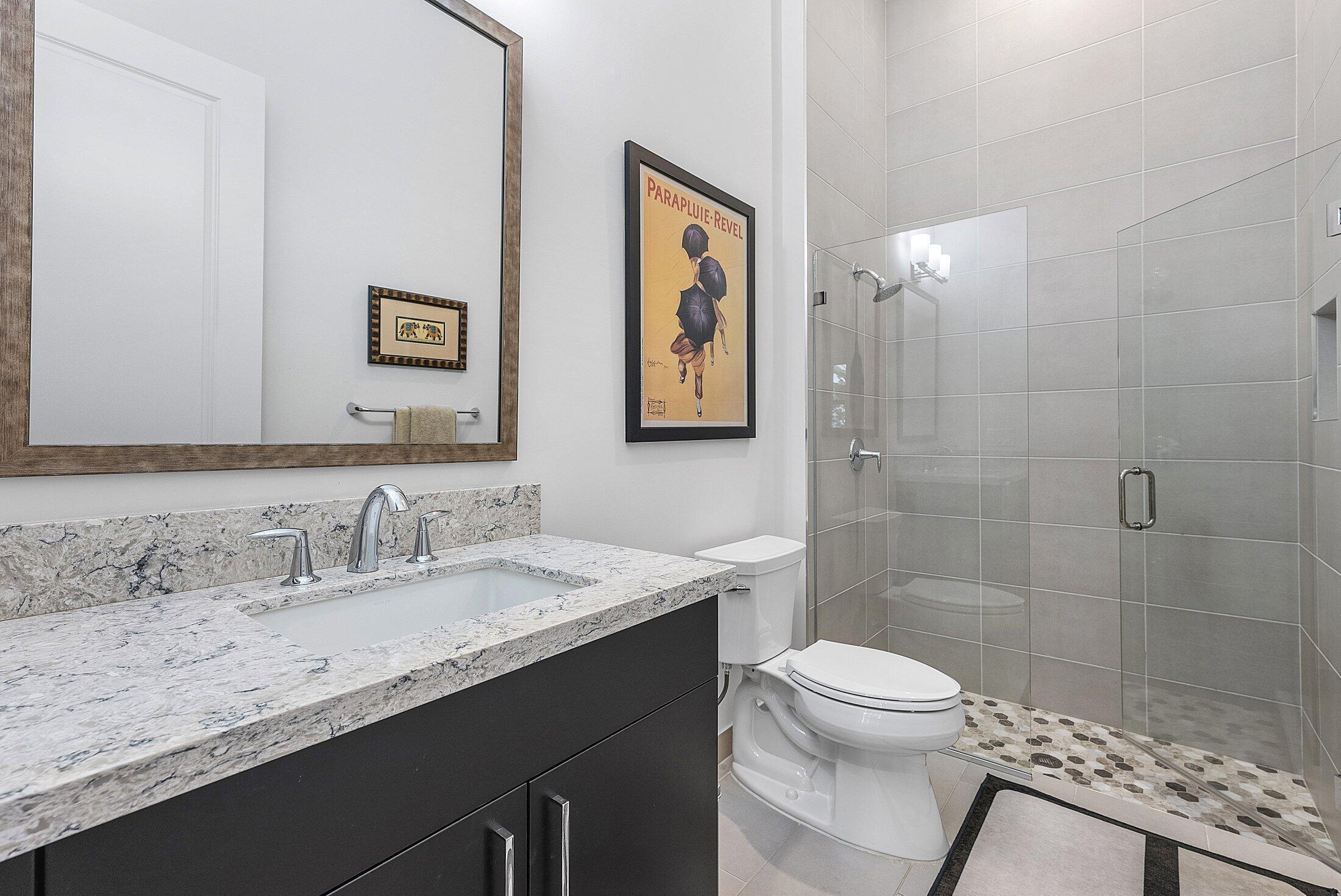 2707 Northwest 75th Street Boca Raton, FL 33496 - Photo 38 of 74 a bathroom with a granite countertop sink a toilet and shower