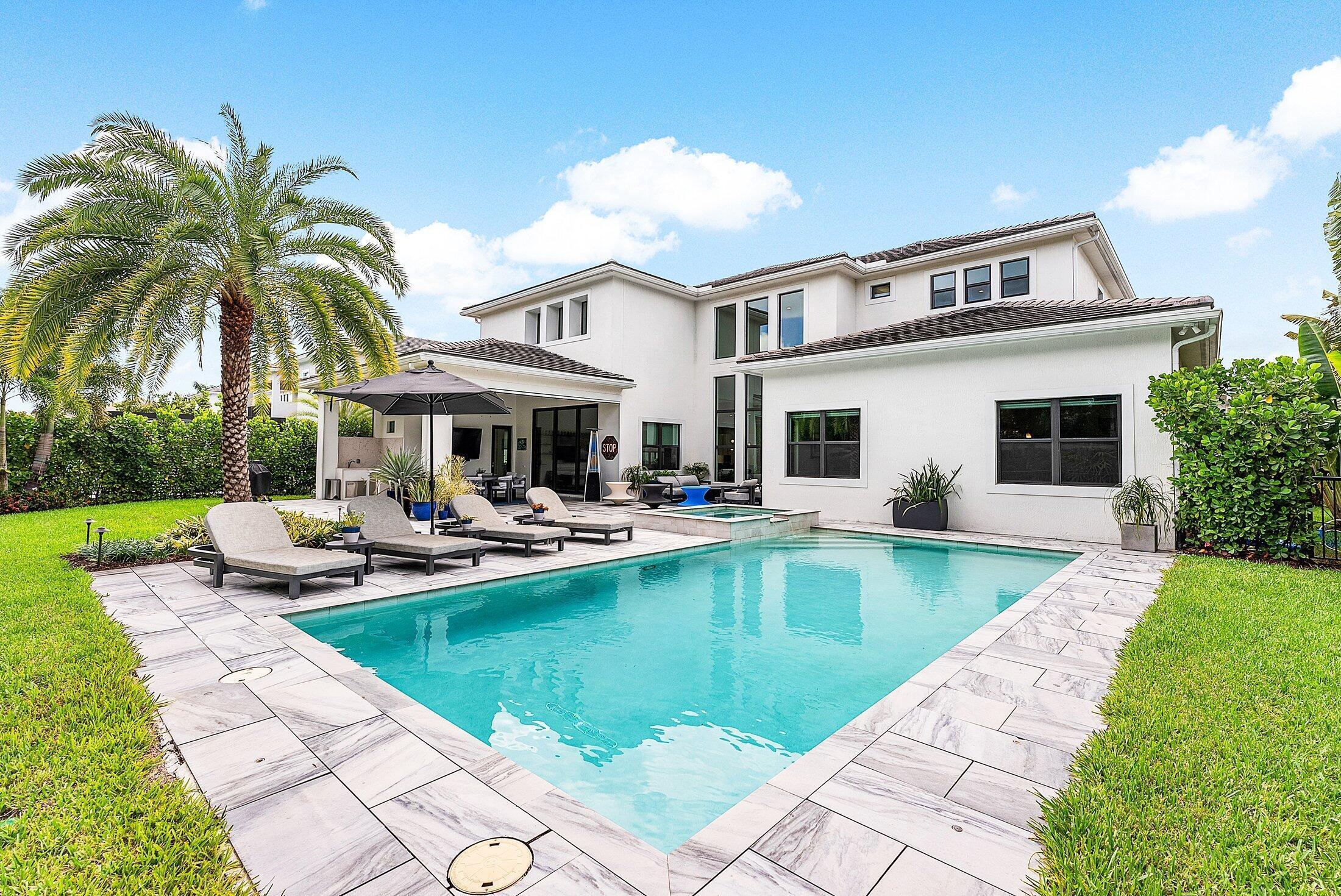 2707 Northwest 75th Street Boca Raton, FL 33496 - Photo 53 of 74 a view of a house with swimming pool having outdoor seating