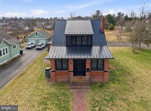 an aerial view of a house with swimming pool patio and balcony