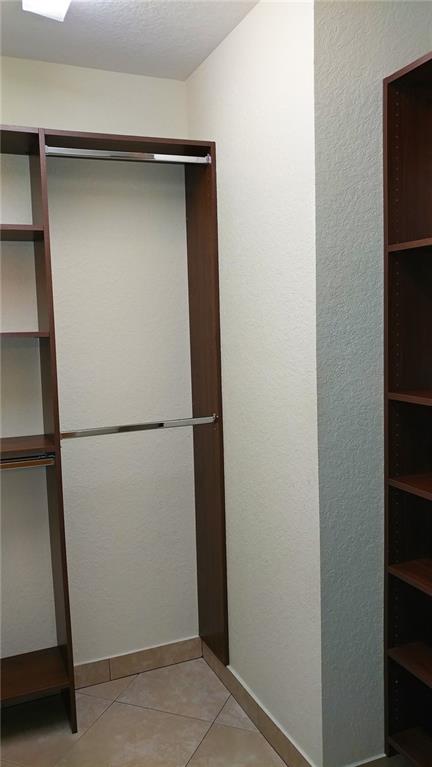 6640 West Sample Road, Unit 6640 Coral Springs, FL 33067 - Photo 14 of 25 a view of walk in closet with empty racks