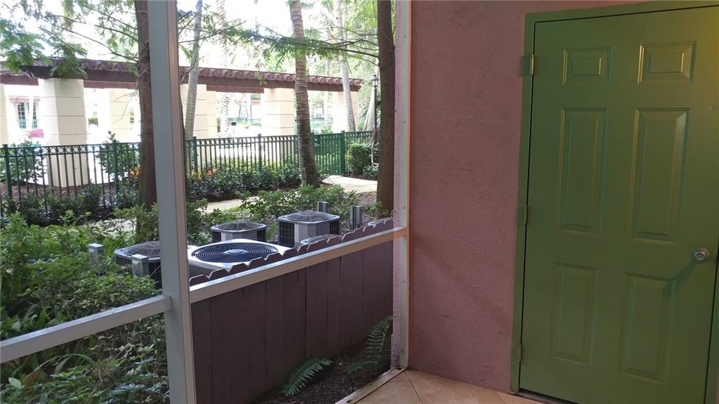 6640 West Sample Road, Unit 6640 Coral Springs, FL 33067 - Photo 16 of 25 a view of a glass door and chair