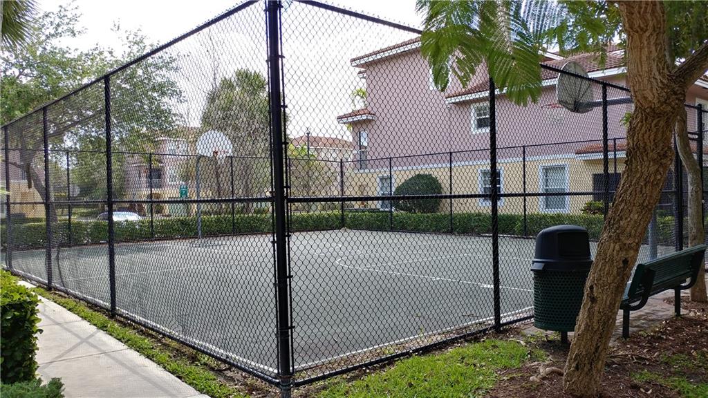 6640 West Sample Road, Unit 6640 Coral Springs, FL 33067 - Photo 18 of 25 a view of a tennis court