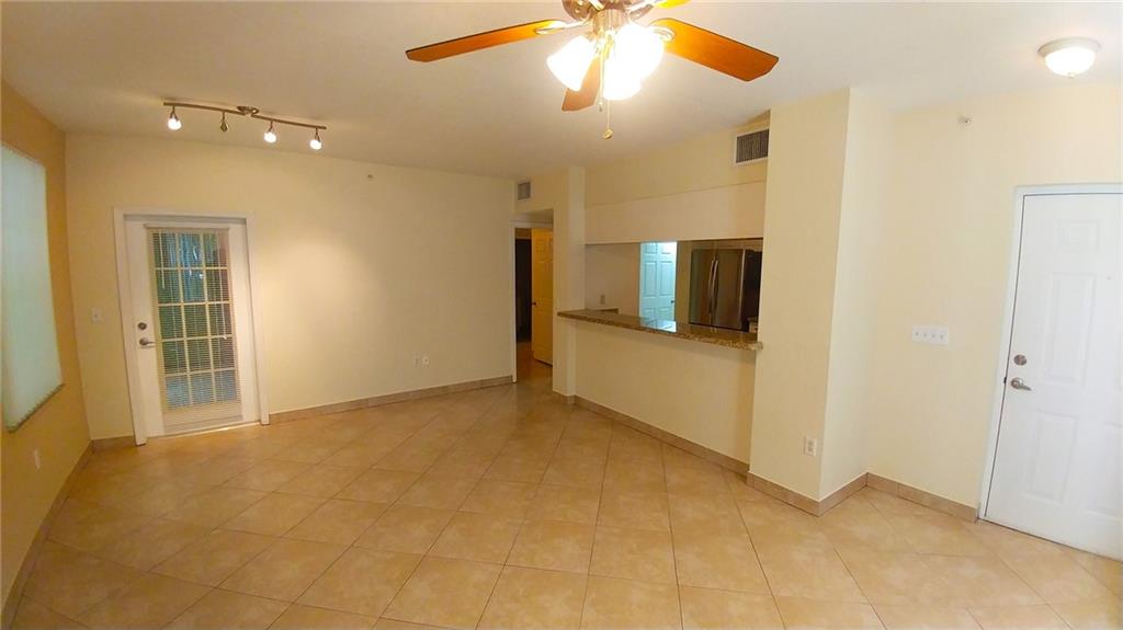 6640 West Sample Road, Unit 6640 Coral Springs, FL 33067 - Photo 5 of 25 en empty room with window and wooden floor