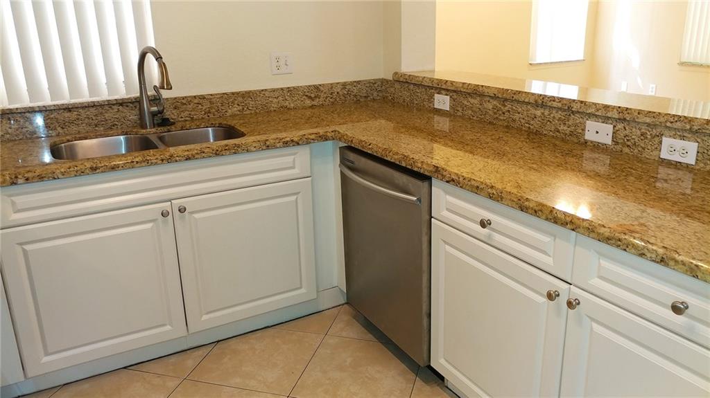 6640 West Sample Road, Unit 6640 Coral Springs, FL 33067 - Photo 7 of 25 a kitchen with a sink and cabinets
