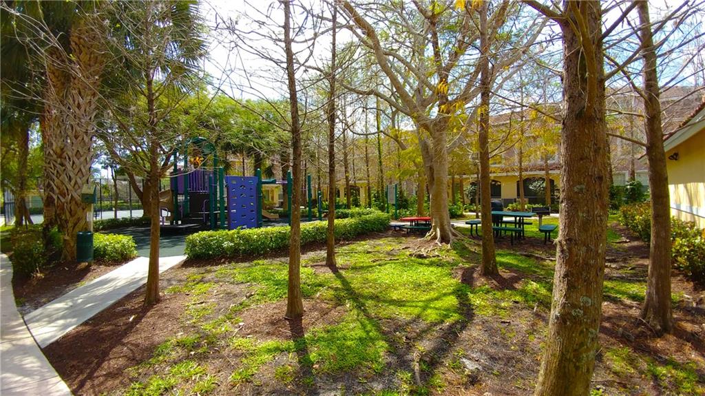 6640 West Sample Road, Unit 6640 Coral Springs, FL 33067 - Photo 8 of 25 a view of a yard with plants and large trees