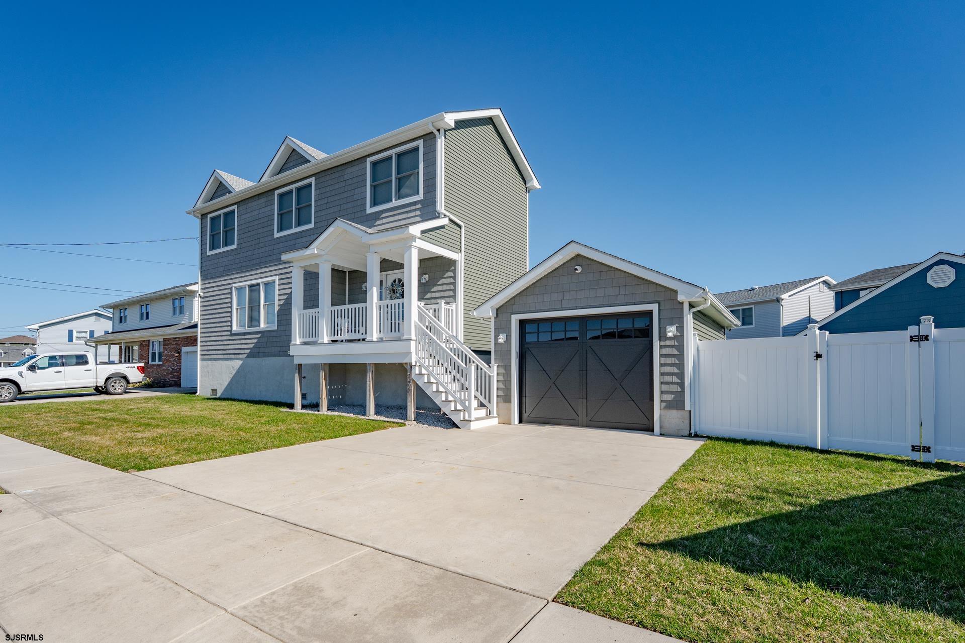 703 Bobby Jones Road Brigantine, NJ 08203 - Photo 2 of 34 a front view of a house with a yard