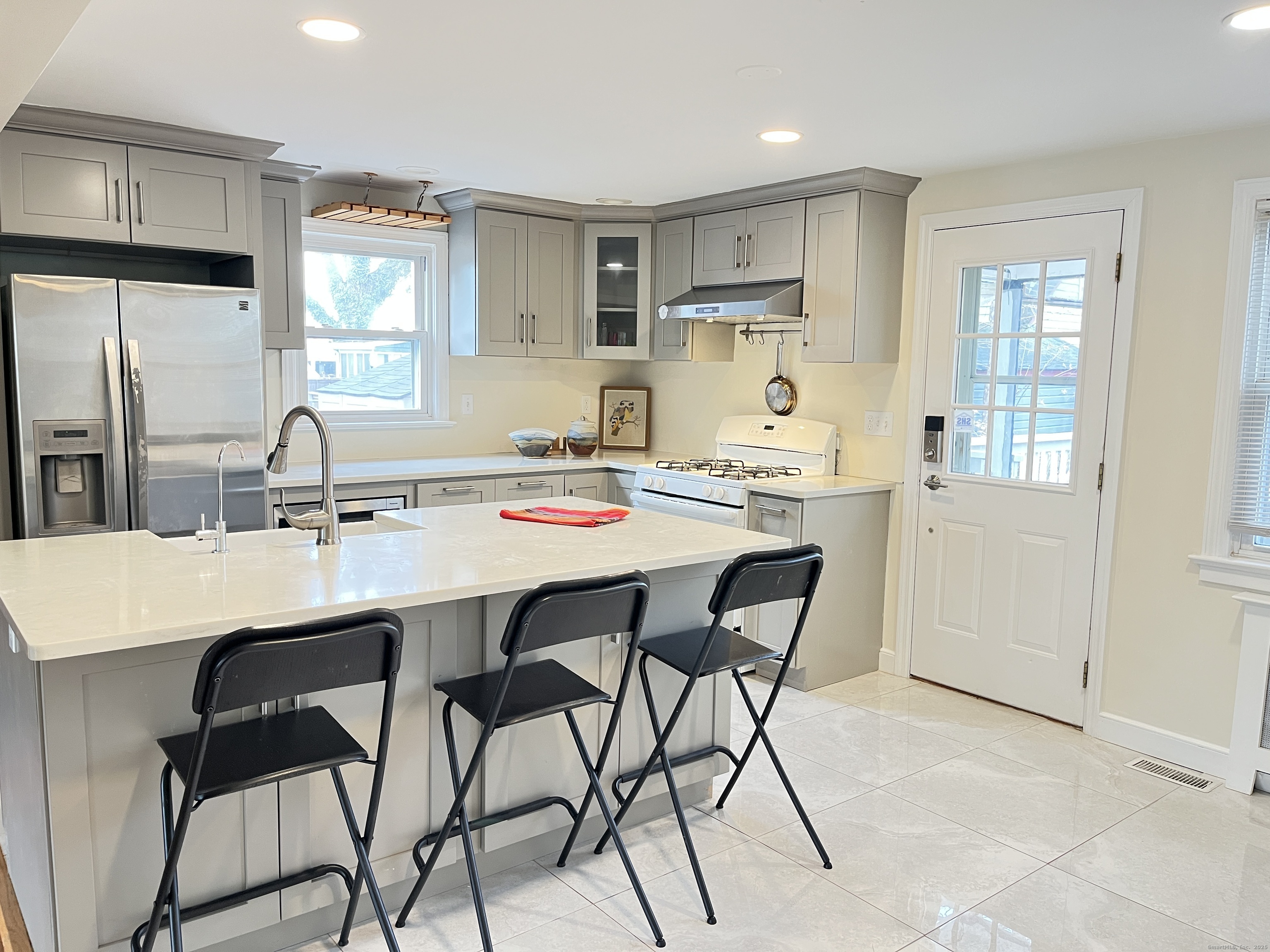 41 Baxter Drive Norwalk, CT 06854 - Photo 4 of 18 a kitchen with a dining table and chairs