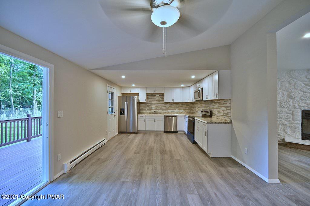 102 Forest Road Dingmans Ferry, PA 18328 - Photo 13 of 75 a large kitchen with a center island and wooden floor