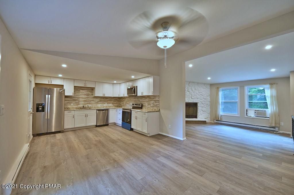 102 Forest Road Dingmans Ferry, PA 18328 - Photo 14 of 75 a view of kitchen with granite countertop cabinets and refrigerator
