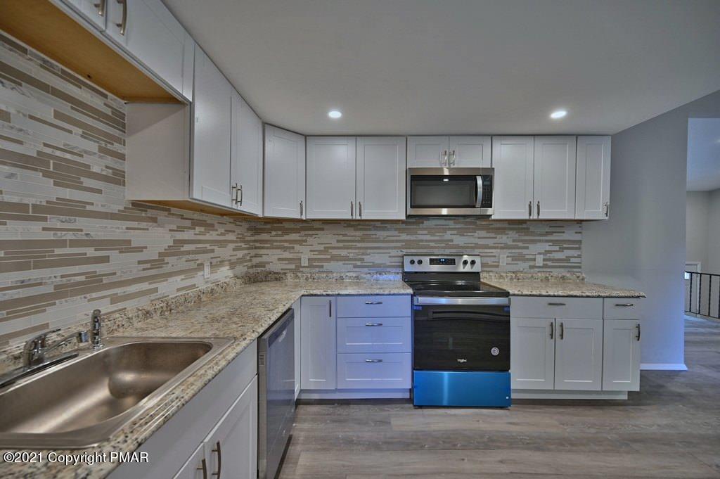 102 Forest Road Dingmans Ferry, PA 18328 - Photo 18 of 75 a kitchen with stainless steel appliances granite countertop a sink and a stove