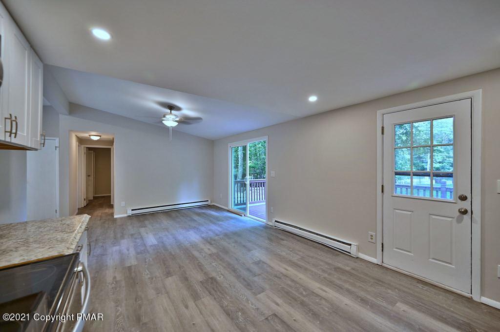 102 Forest Road Dingmans Ferry, PA 18328 - Photo 20 of 75 an empty room with wooden floor and windows