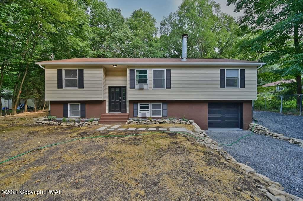 102 Forest Road Dingmans Ferry, PA 18328 - Photo 2 of 75 a front view of a house with a garden