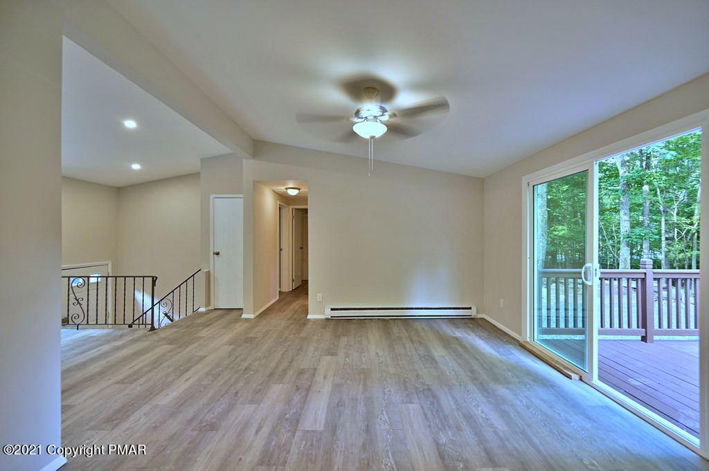 102 Forest Road Dingmans Ferry, PA 18328 - Photo 21 of 75 a view of an empty room with a window and wooden floor