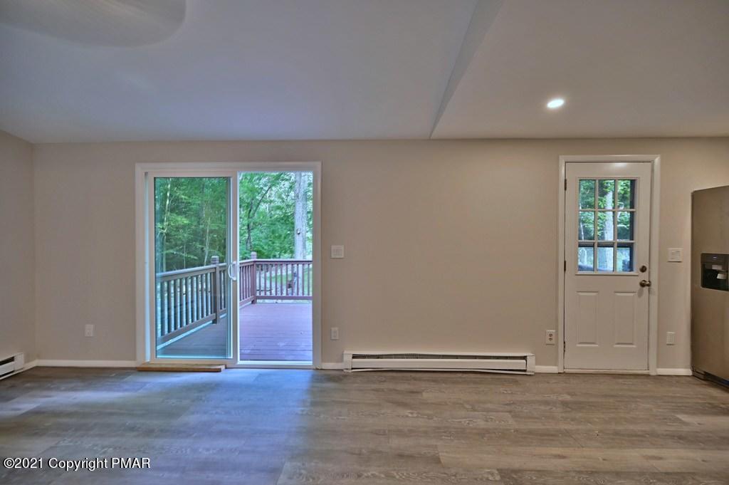 102 Forest Road Dingmans Ferry, PA 18328 - Photo 23 of 75 an empty room with wooden floor and windows