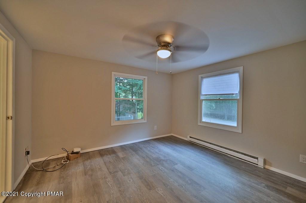 102 Forest Road Dingmans Ferry, PA 18328 - Photo 25 of 75 an empty room with wooden floor and windows