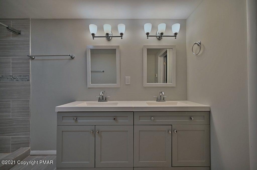 102 Forest Road Dingmans Ferry, PA 18328 - Photo 30 of 75 a bathroom with a sink and a mirror