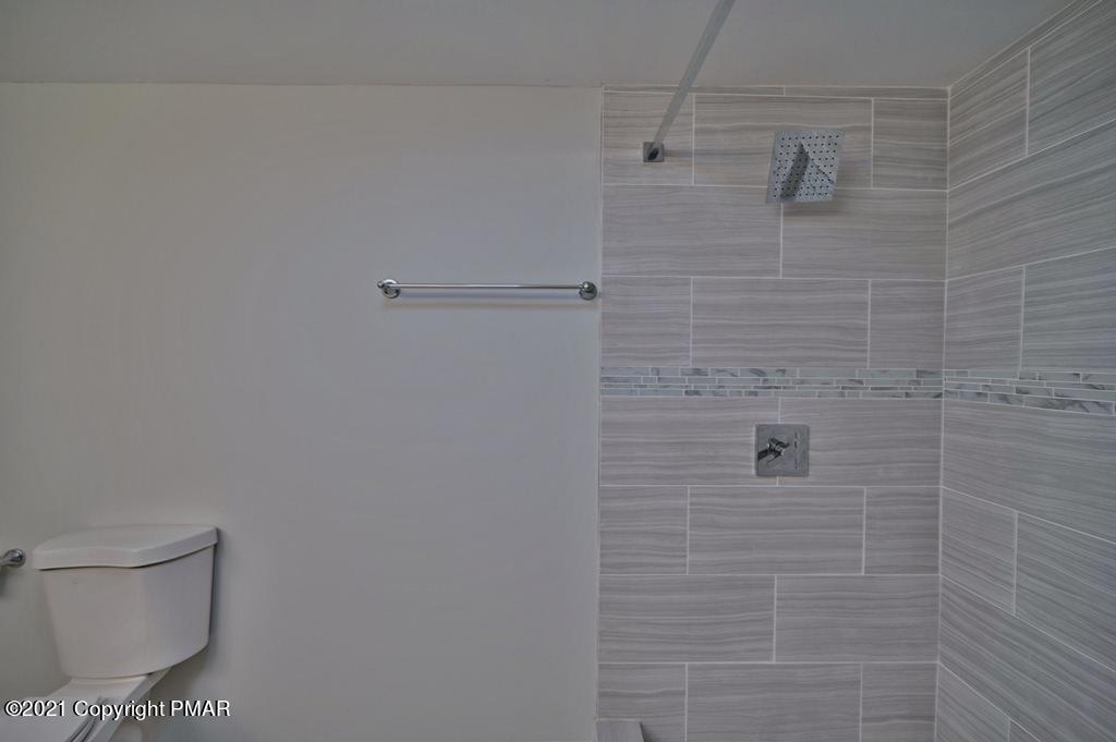 102 Forest Road Dingmans Ferry, PA 18328 - Photo 34 of 75 a bathroom with a toilet and a shower