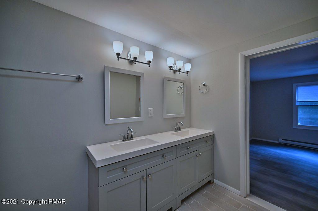 102 Forest Road Dingmans Ferry, PA 18328 - Photo 35 of 75 a bathroom with a double vanity sink and a mirror
