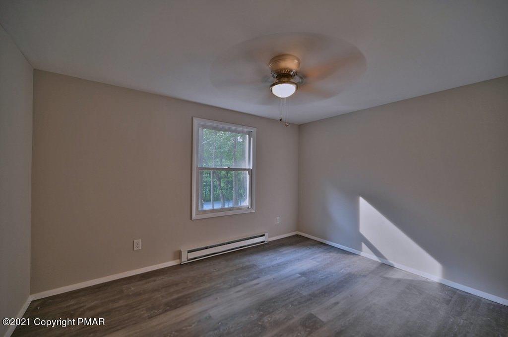 102 Forest Road Dingmans Ferry, PA 18328 - Photo 37 of 75 an empty room with wooden floor and windows