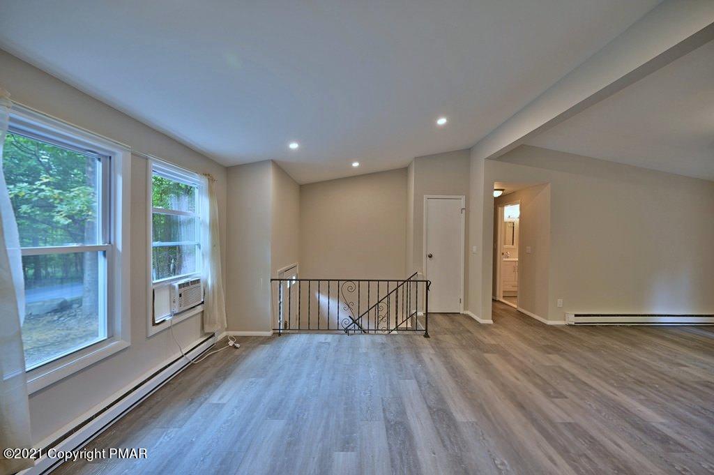 102 Forest Road Dingmans Ferry, PA 18328 - Photo 4 of 75 a view of hallway with a large window and wooden floor