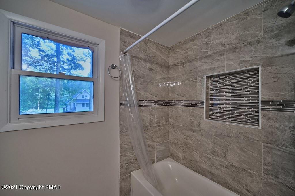 102 Forest Road Dingmans Ferry, PA 18328 - Photo 41 of 75 a bathroom with a bathtub and a shower