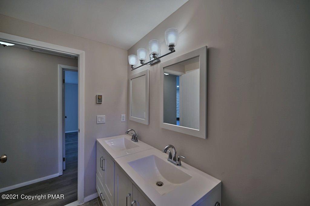 102 Forest Road Dingmans Ferry, PA 18328 - Photo 42 of 75 a bathroom with a sink mirror and vanity