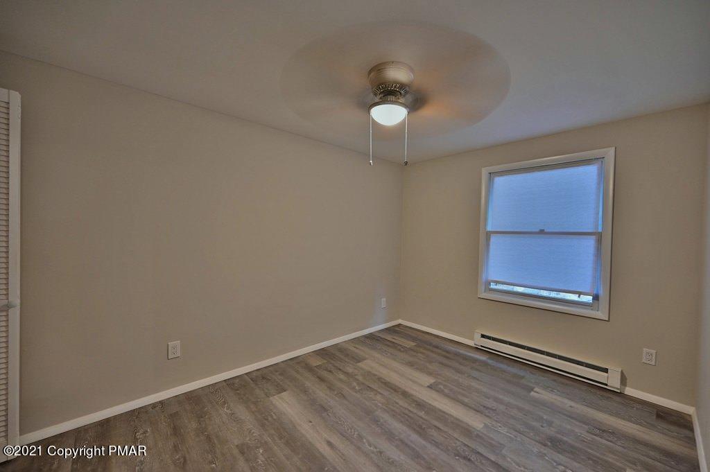 102 Forest Road Dingmans Ferry, PA 18328 - Photo 44 of 75 an empty room with wooden floor and windows