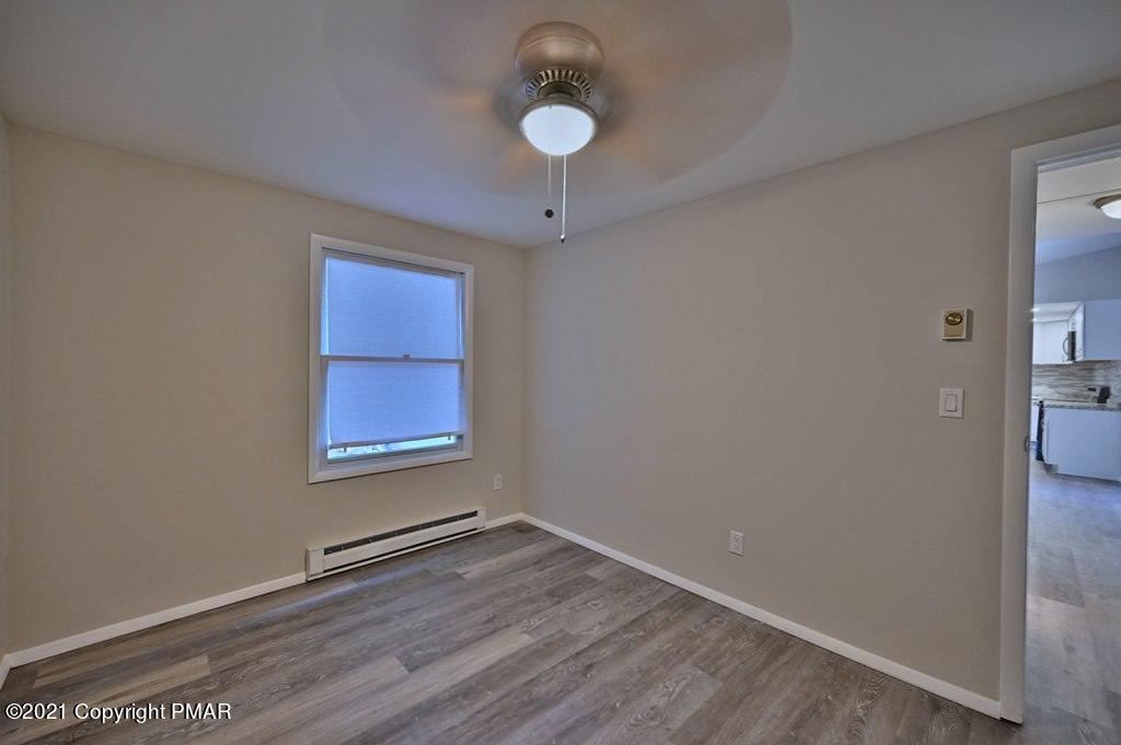 102 Forest Road Dingmans Ferry, PA 18328 - Photo 45 of 75 a view of an empty room with wooden floor and a window