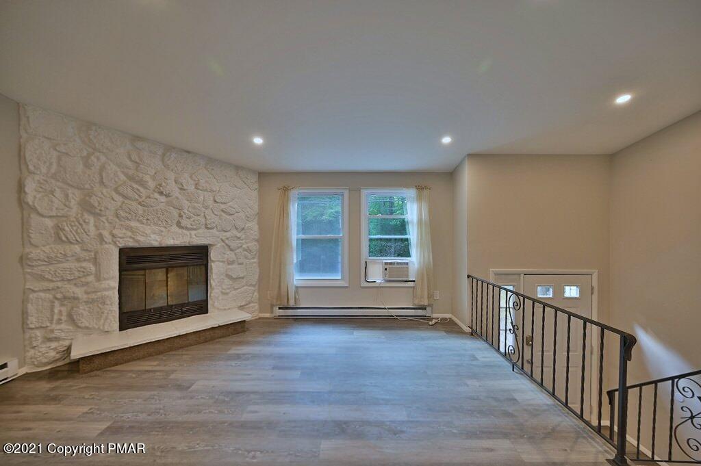 102 Forest Road Dingmans Ferry, PA 18328 - Photo 5 of 75 a view of an empty room with wooden floor and a window