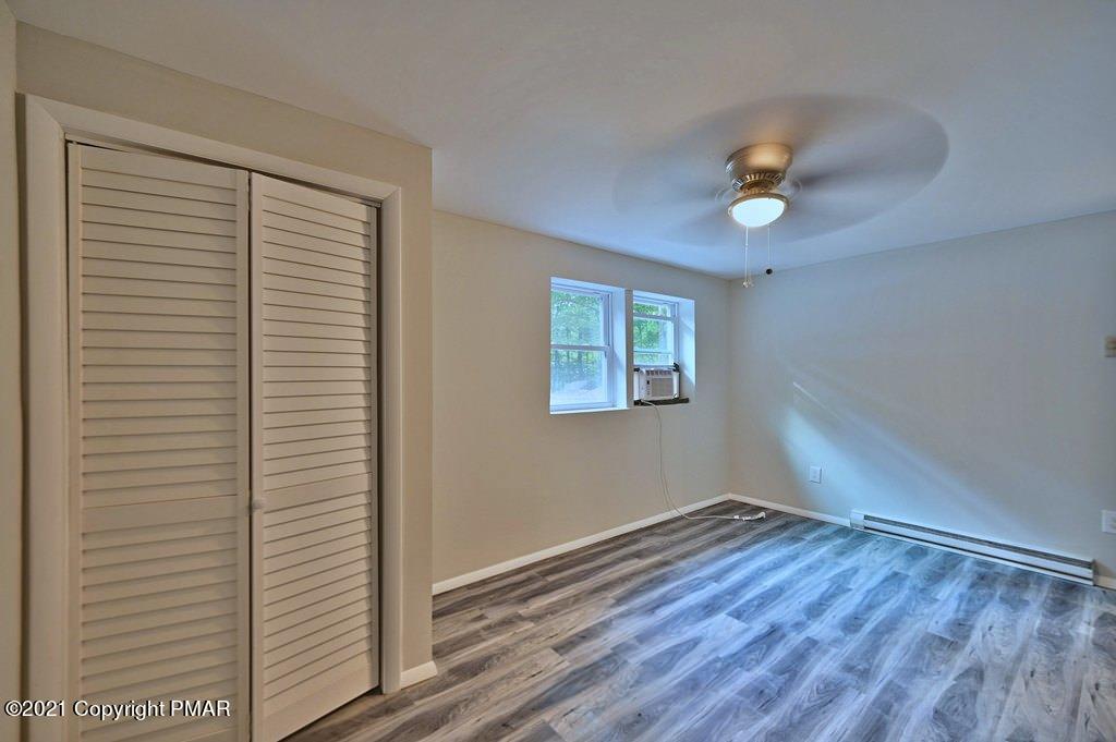 102 Forest Road Dingmans Ferry, PA 18328 - Photo 52 of 75 a view of an empty room with wooden floor and a window