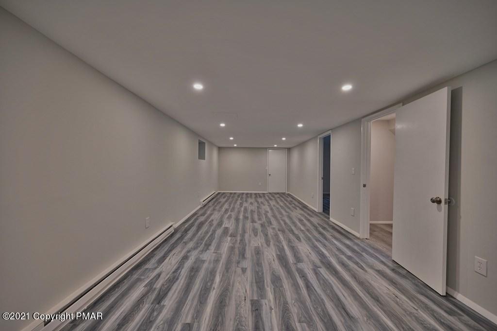 102 Forest Road Dingmans Ferry, PA 18328 - Photo 57 of 75 a view of empty room with wooden floor