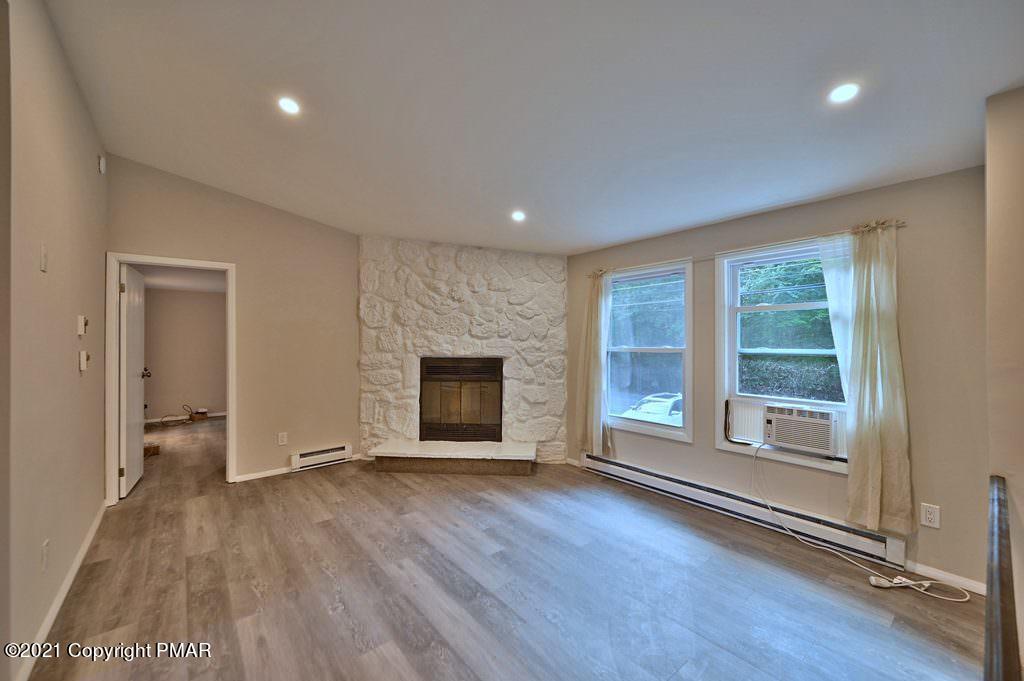 102 Forest Road Dingmans Ferry, PA 18328 - Photo 6 of 75 a view of an empty room with wooden floor and a window