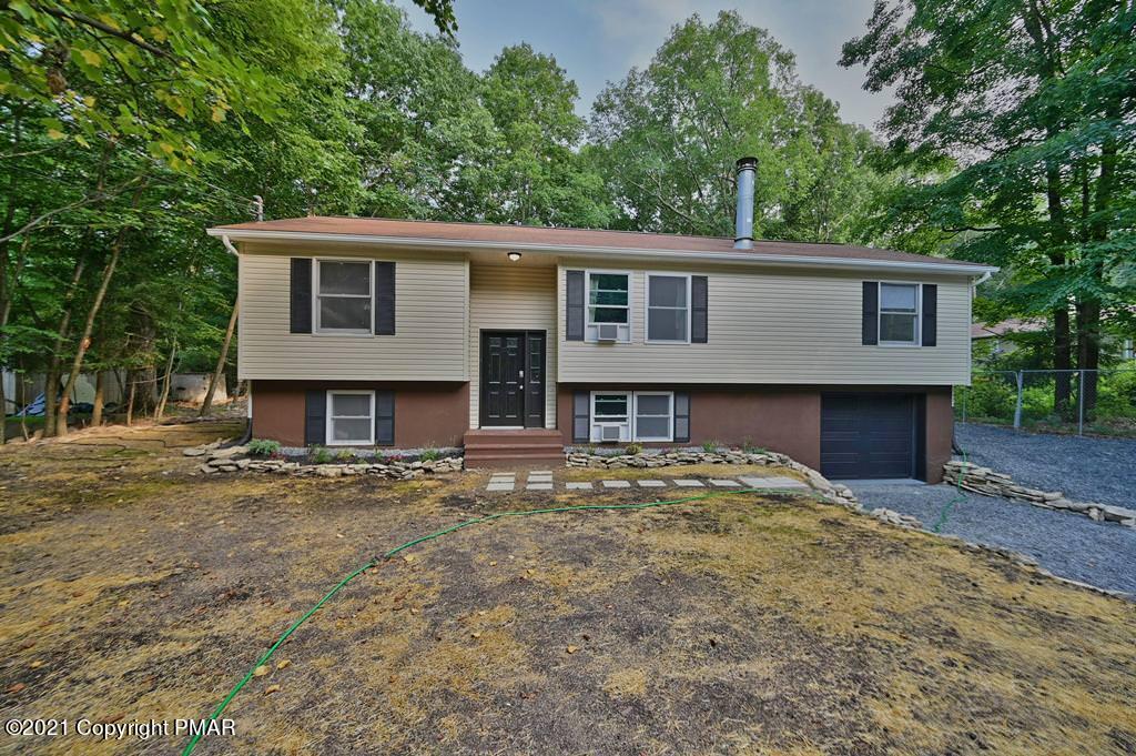 102 Forest Road Dingmans Ferry, PA 18328 - Photo 65 of 75 a front view of a house with a garden