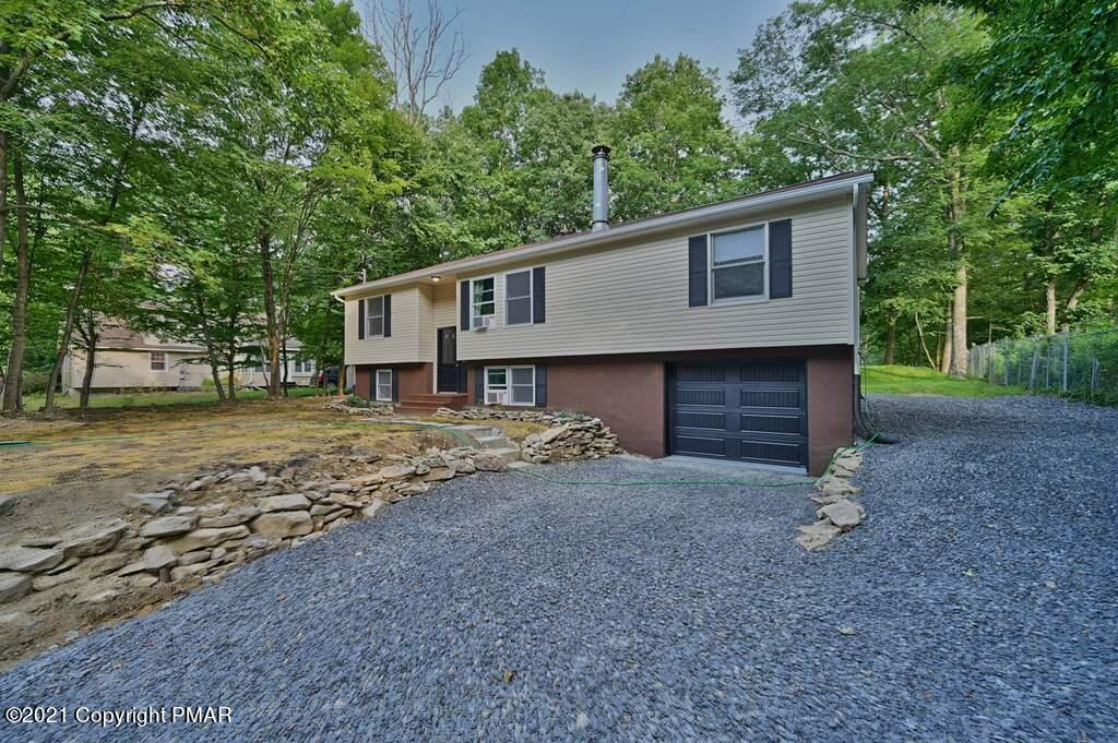 102 Forest Road Dingmans Ferry, PA 18328 - Photo 72 of 75 a view of a house with a yard and large tree