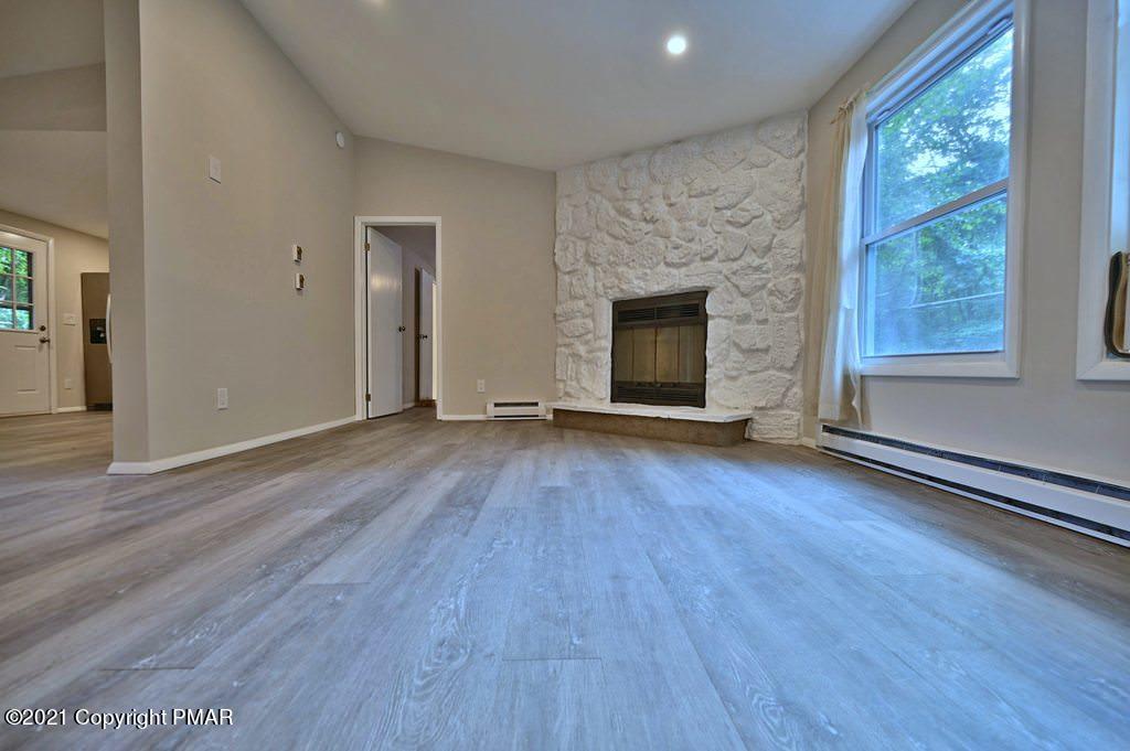 102 Forest Road Dingmans Ferry, PA 18328 - Photo 10 of 75 an empty room with wooden floor and windows