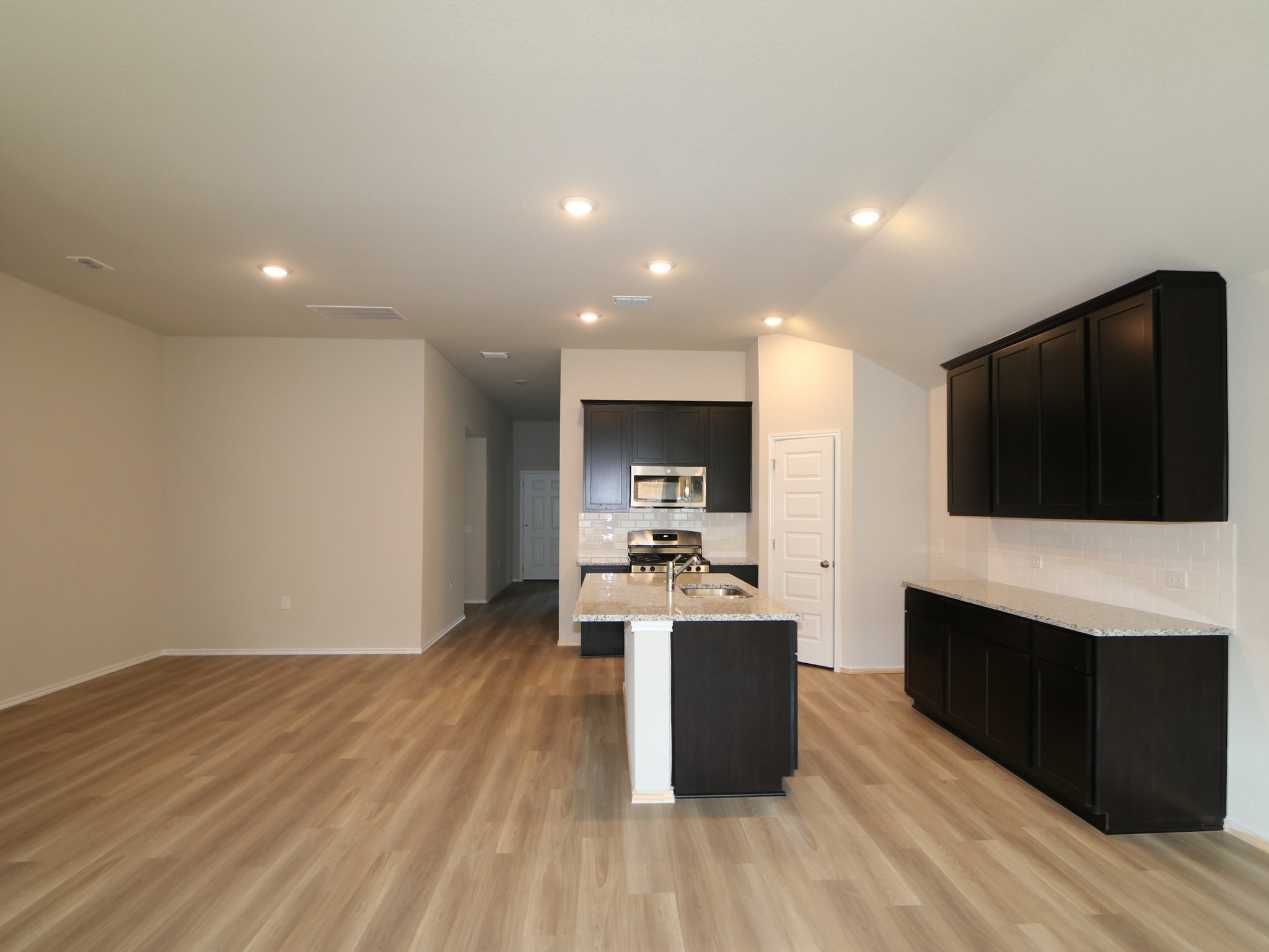 9217 Furman Drive Austin, TX 78747 - Photo 2 of 16 a view of living room with stainless steel appliances wooden floor and large window