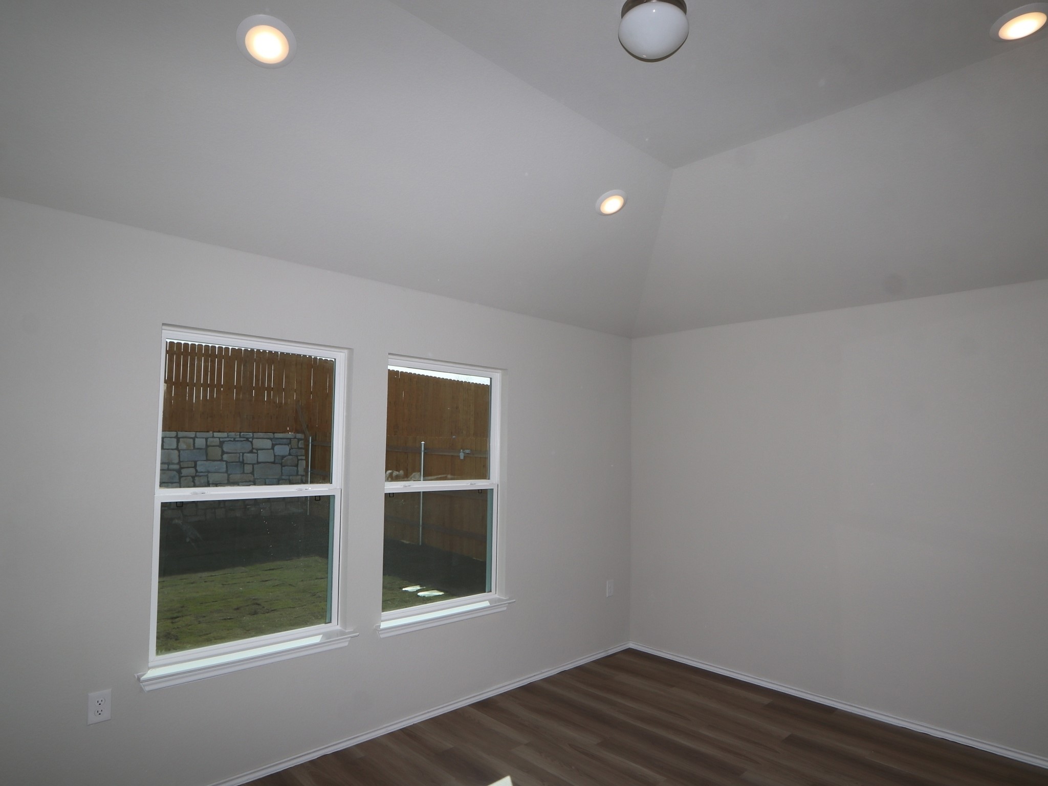 9217 Furman Drive Austin, TX 78747 - Photo 8 of 16 a view of an empty room with wooden floor and a window