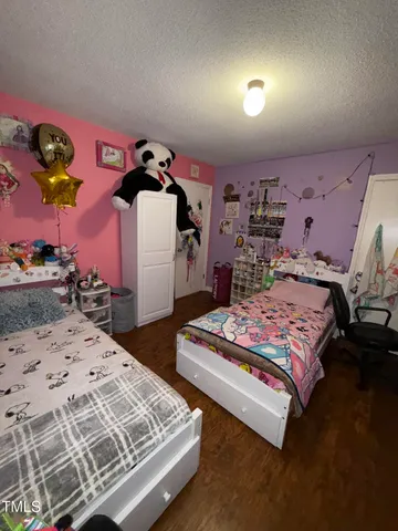 a bedroom with a bed and dresser