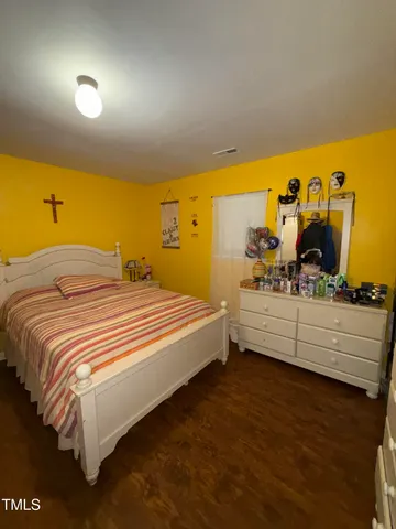 a bedroom with a bed and ceiling fan